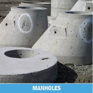 Concrete manholes on gravel surface